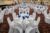 rows of white tables set up for wedding