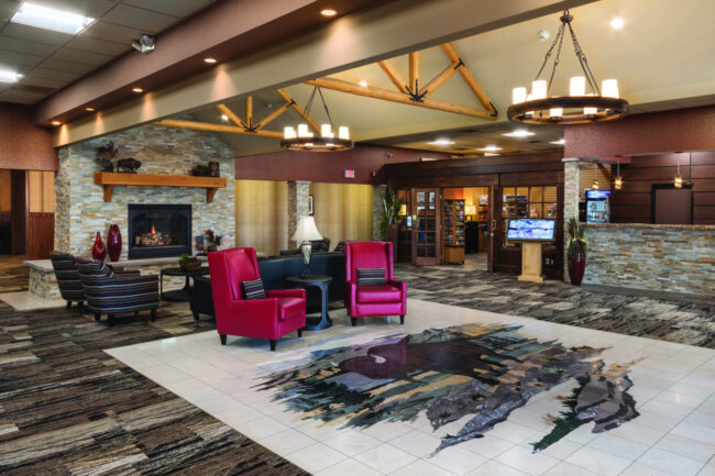 Interior of BW Rapid city with front desk, chairs, and fireplace
